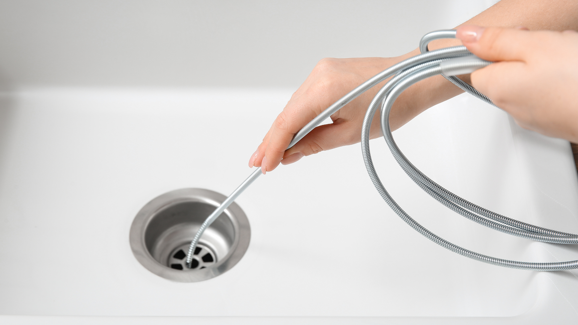 Drain Cleaning — professional plumber at work