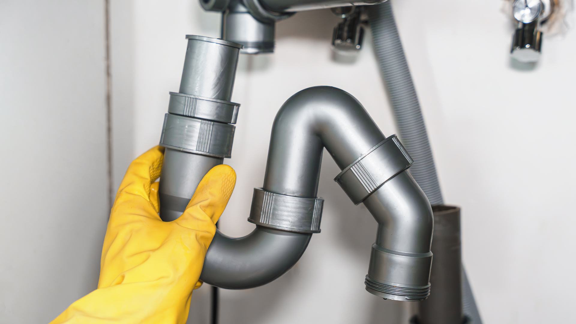 Kitchen Drain Cleaning — professional plumber at work