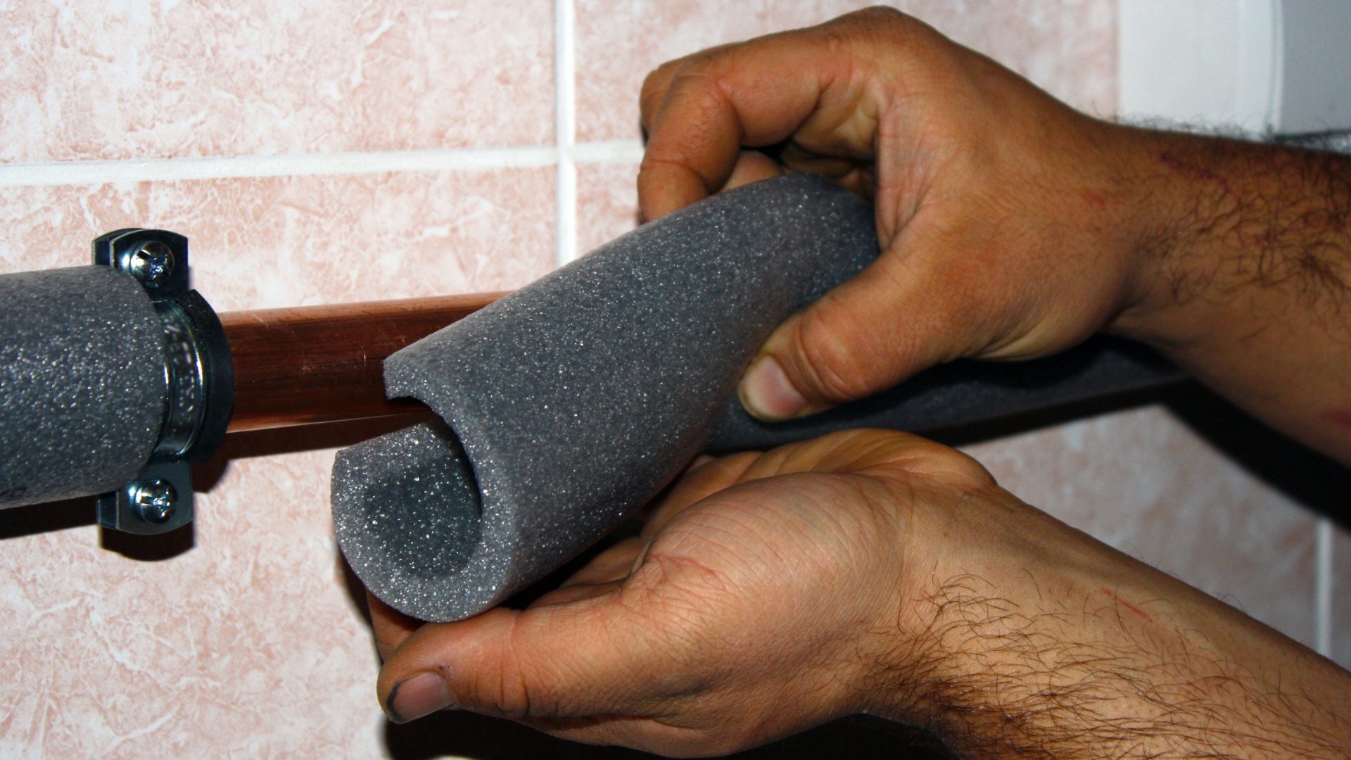 Pipe Insulation — professional plumber at work